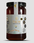 Jar of Troy Greek Raw Honey Oak Honey on a light gray background