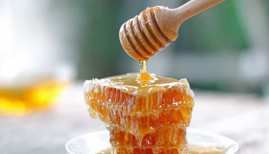 Gently handled raw honey showing natural texture and crystallization