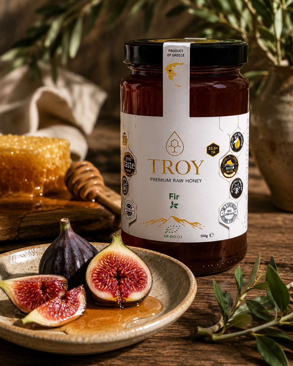 Troy Greek Raw Honey Fir Honey served with fresh figs and honeycomb in a Mediterranean food setting.