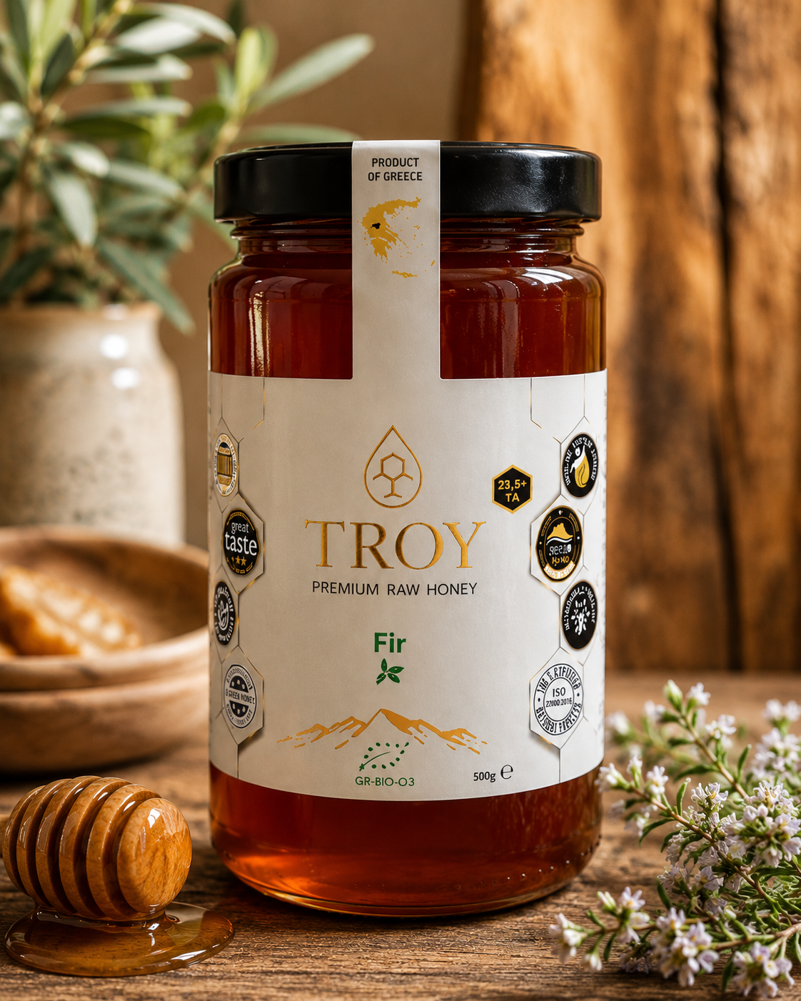 Troy Greek Raw Honey jar displayed in a rustic kitchen with natural ingredients and warm Mediterranean 