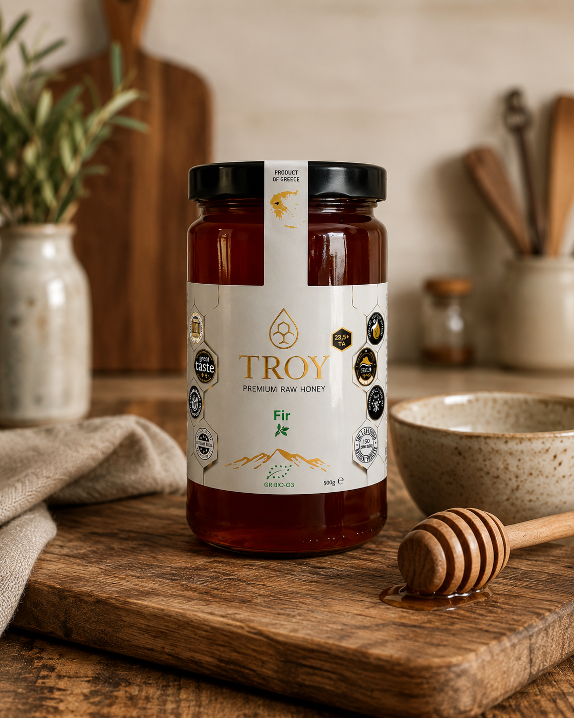 Troy Greek Raw Honey jar displayed in a rustic kitchen with natural ingredients and warm Mediterranean styling.